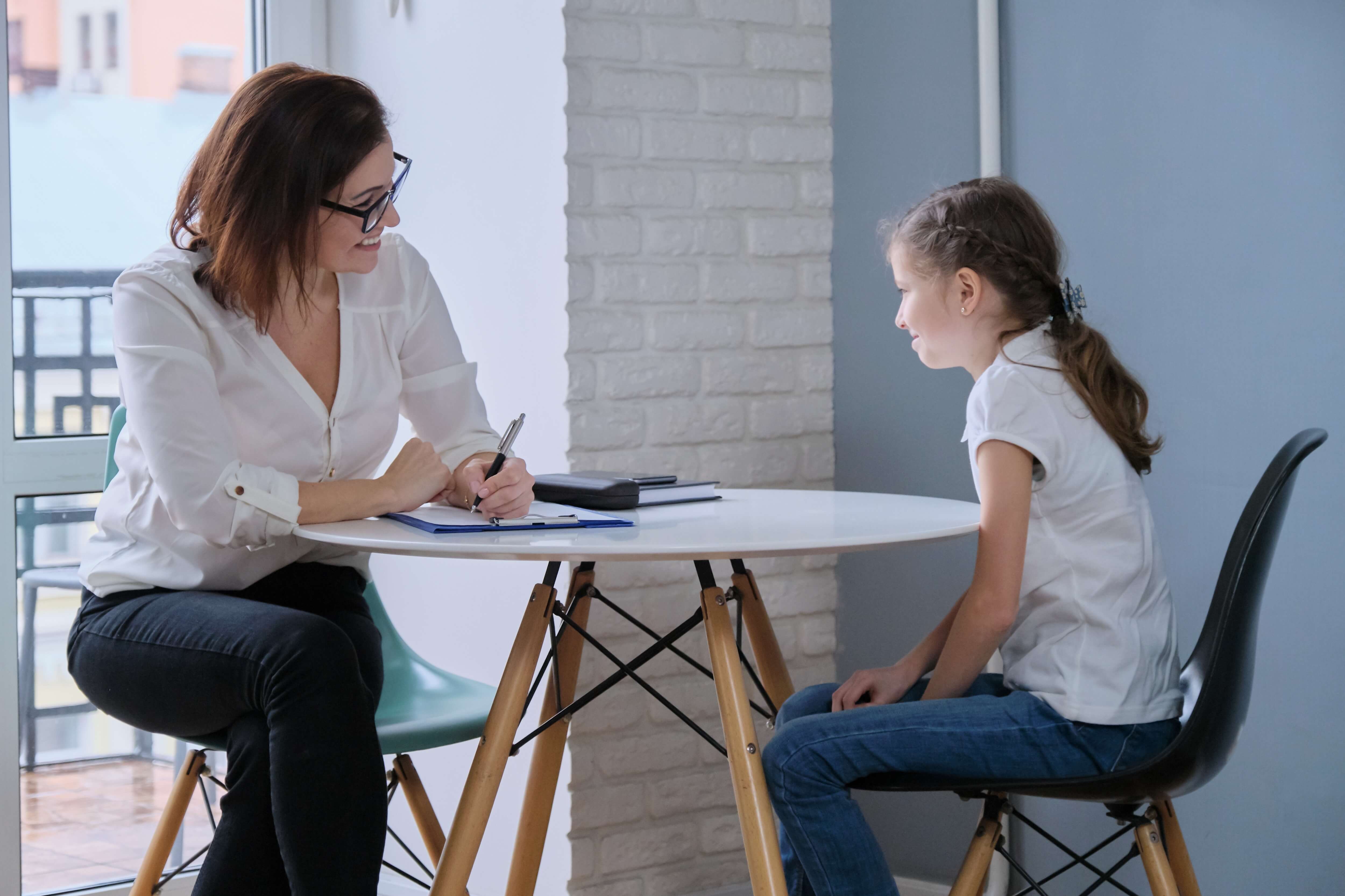 woman and child talking at round table