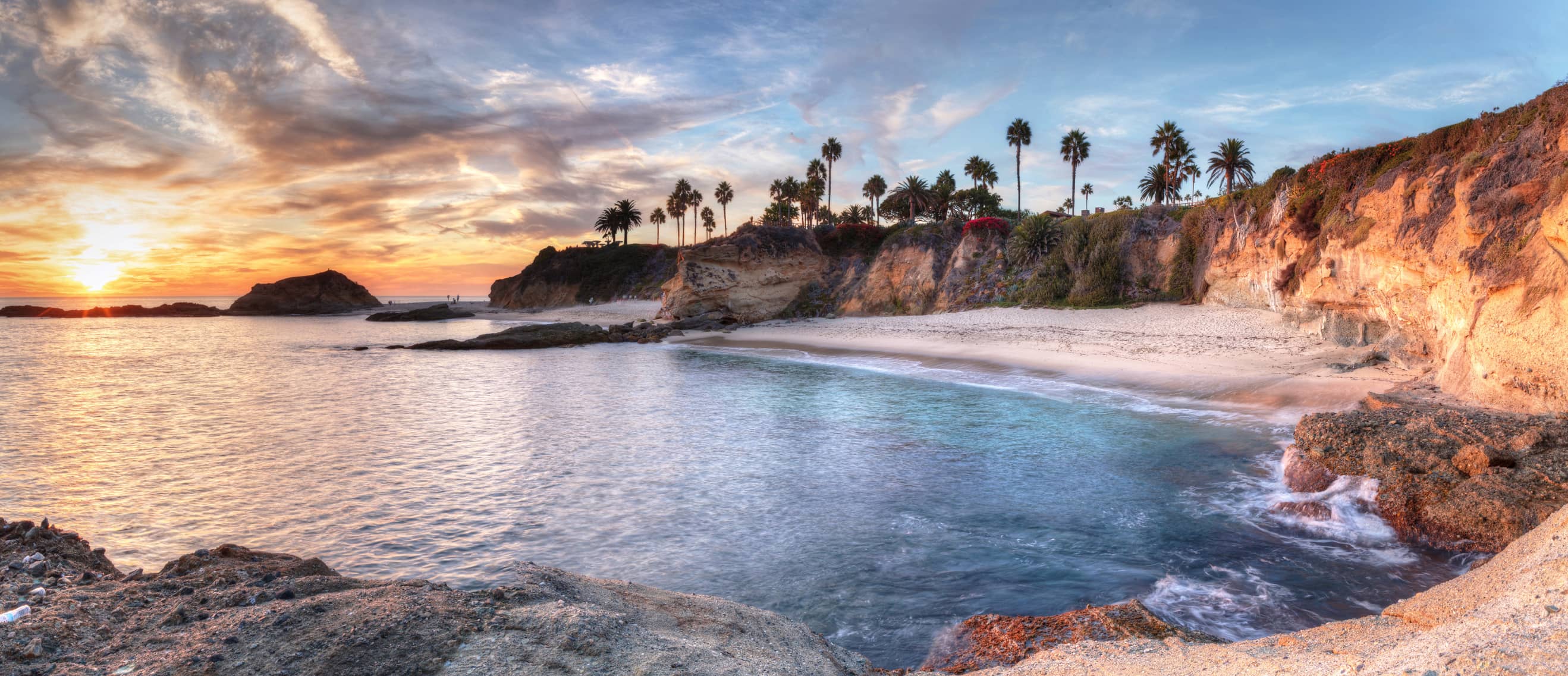 Sunet overlooking white sandy beach with blue waters. Sunet overlooking white sandy beach with blue waters.