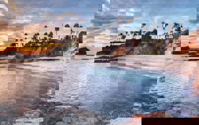 Sunet overlooking white sandy beach with blue waters. Sunet overlooking white sandy beach with blue waters.